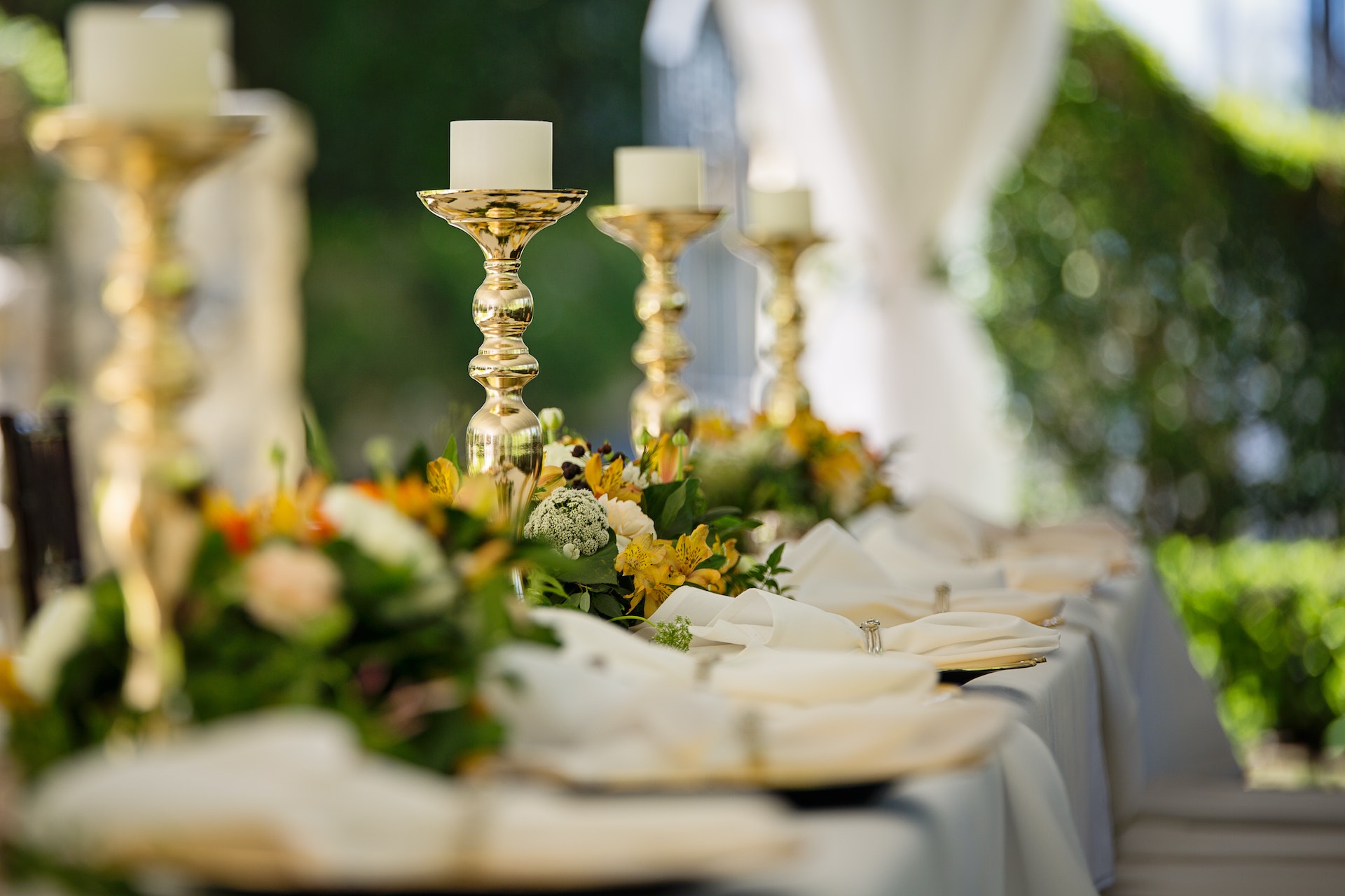 Golden candlesticks on a long table